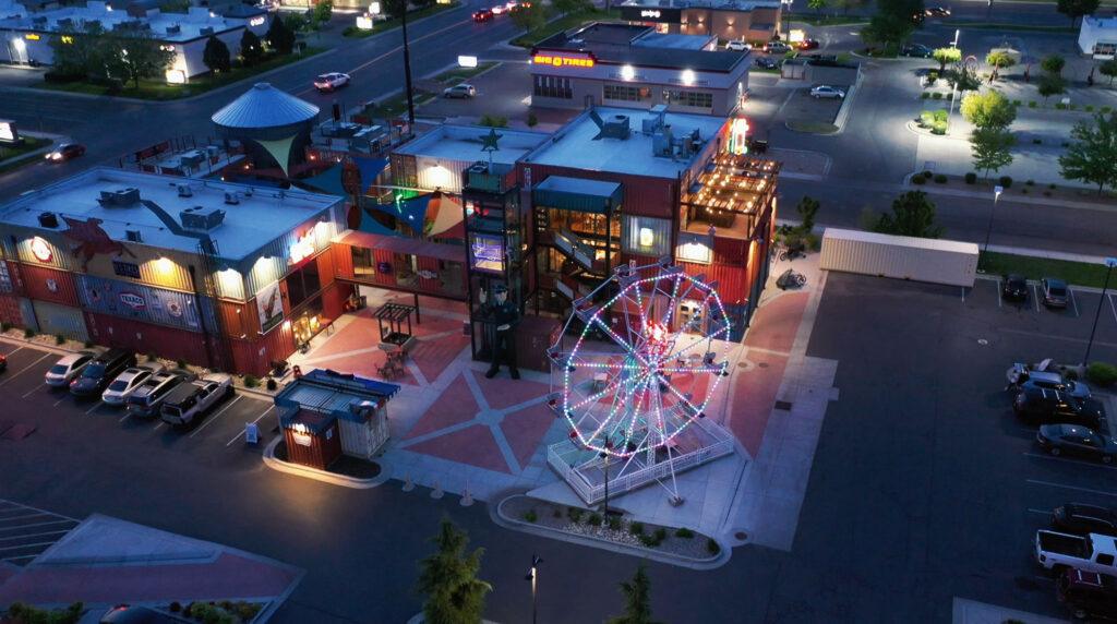 Drone view of a ferris wheel with permanent lighting