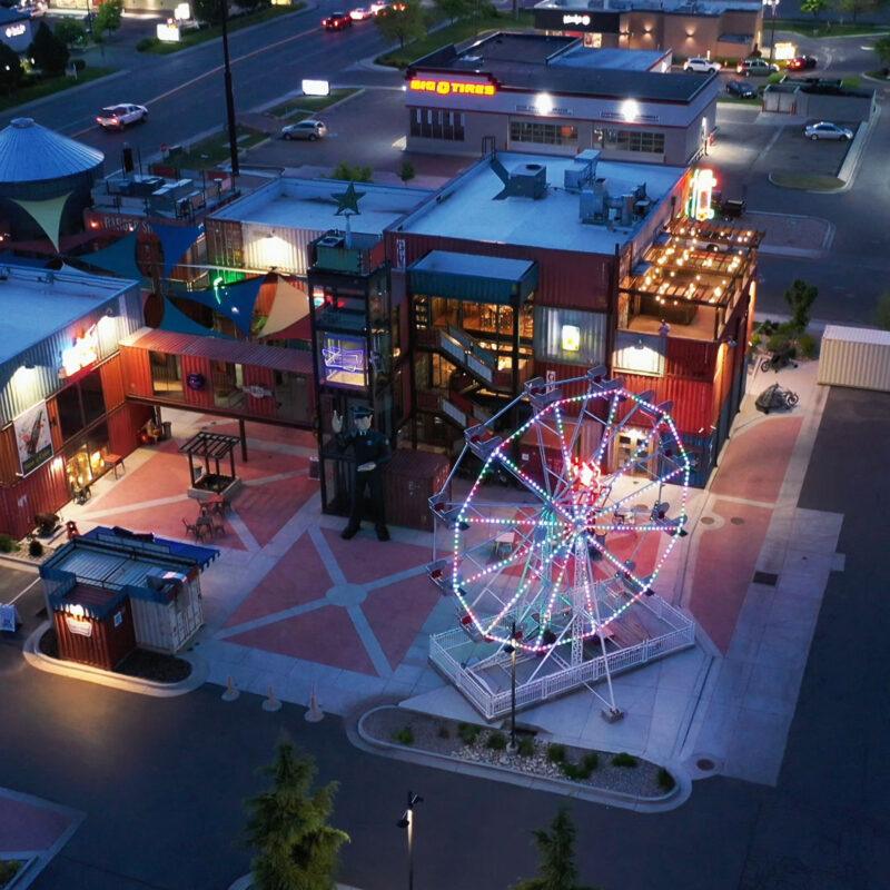 Drone view of a ferris wheel with permanent lighting